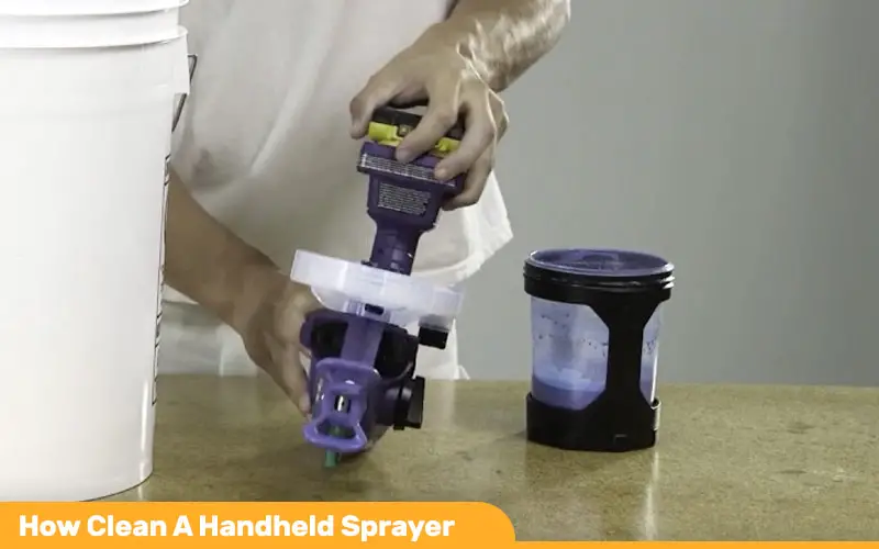 An image showing a homeowner cleaning an electric handheld paint sprayer