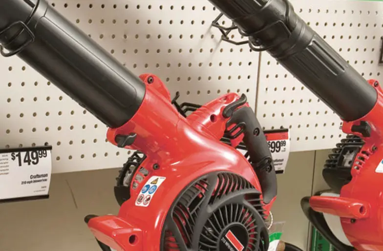 An image of leaf blowers on a shelf in a shop