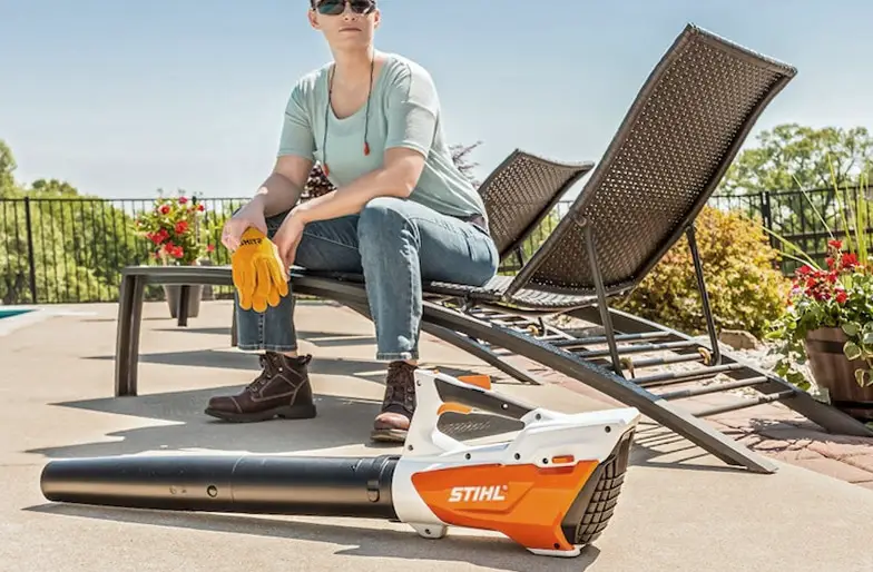 An example of a homeowner sitting next to a STIHL leaf blower