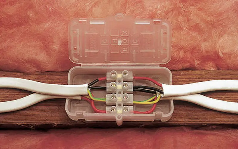 A picture of connecting damaged wires in a chocolate junction box