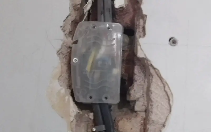A picture of a finished junction box repair for drilled electric cables